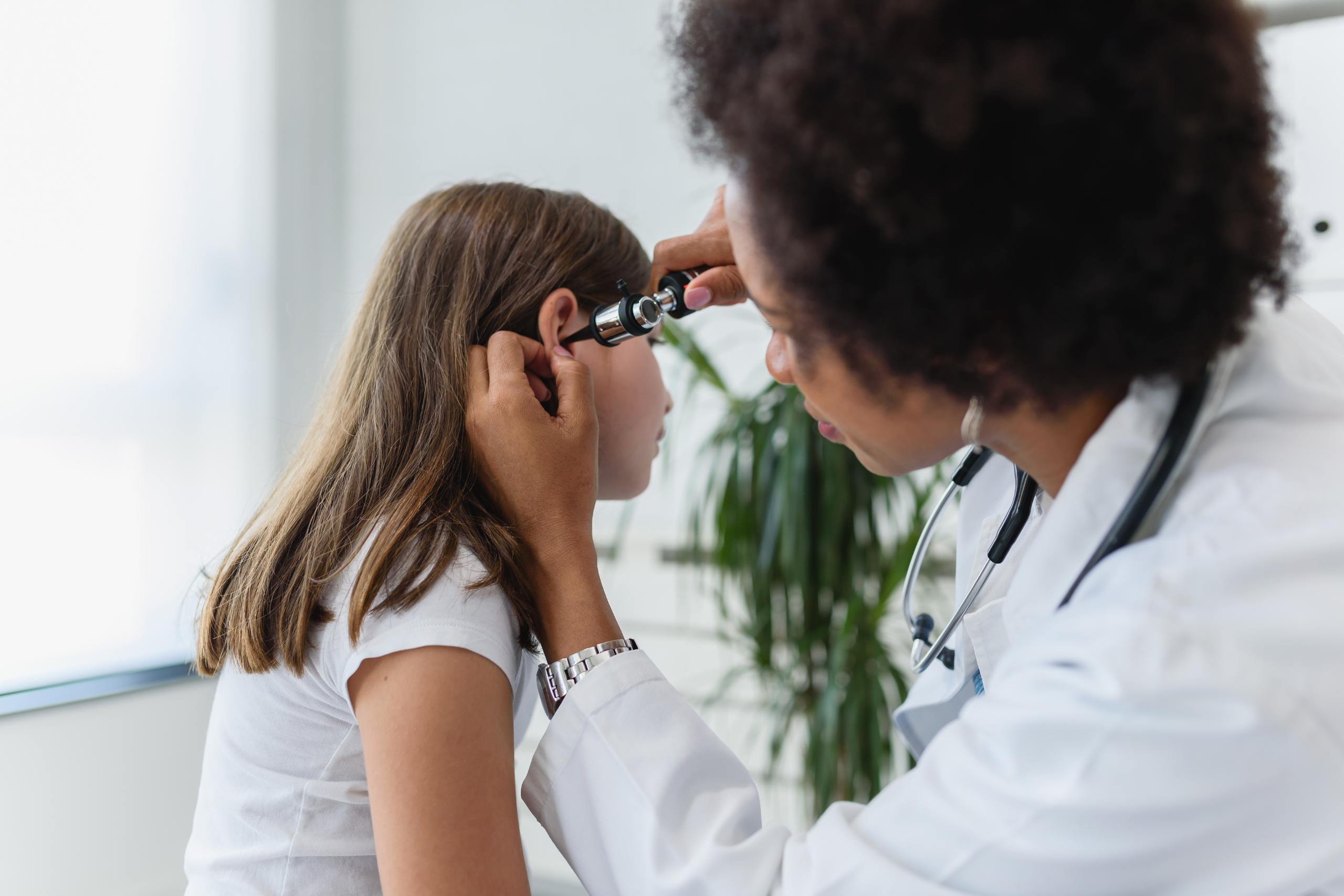 Doctor checks for ear infection