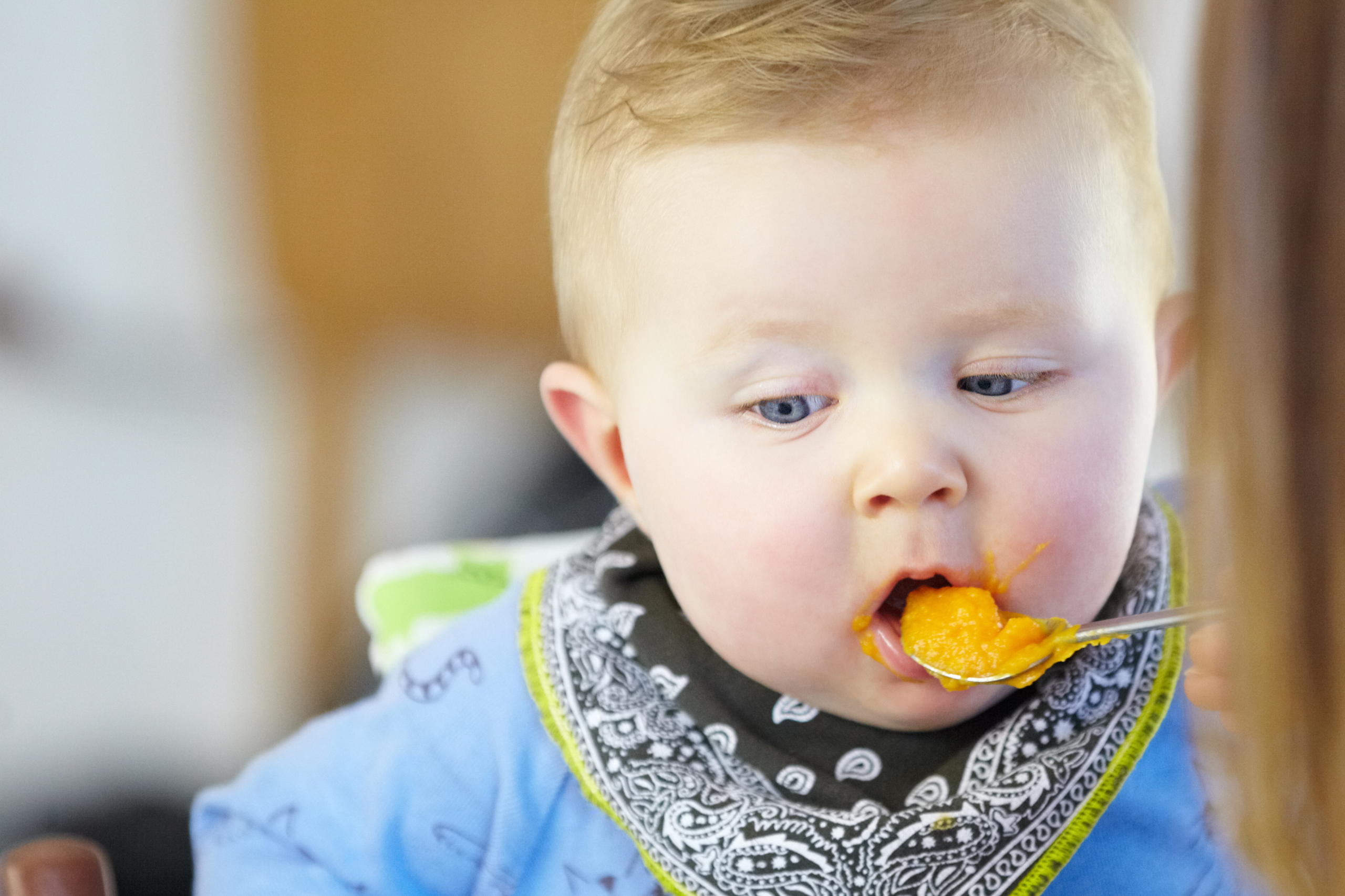 infant trying food