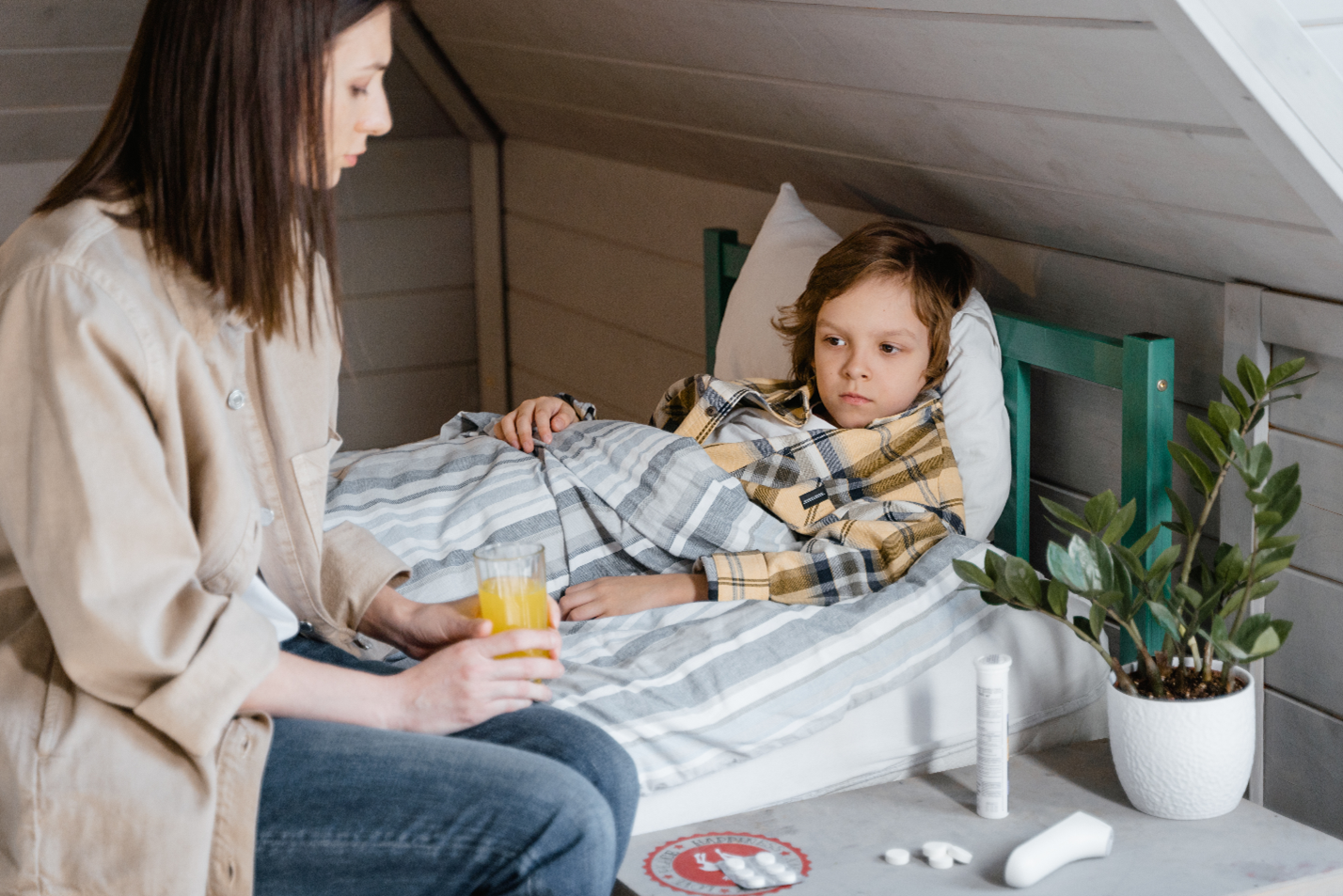 mom checking on child sick in bed